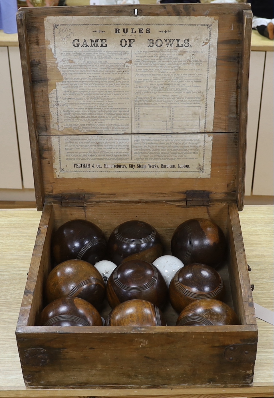 A cased Feltham & Co lignum vitae and ceramic bowls set, rules to inner lid